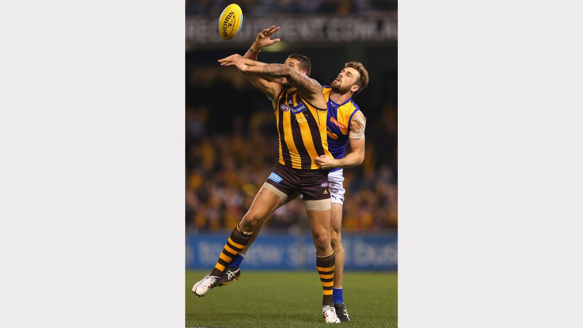 Eric Mackenzie spoils Lance Franklin's attempted mark. Photo: Getty Images.