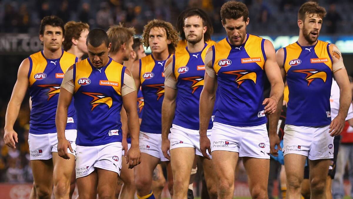 The Eagles look dejected after losing the round 13 AFL match against the Hawthorn Hawks. Photo: Getty Images.