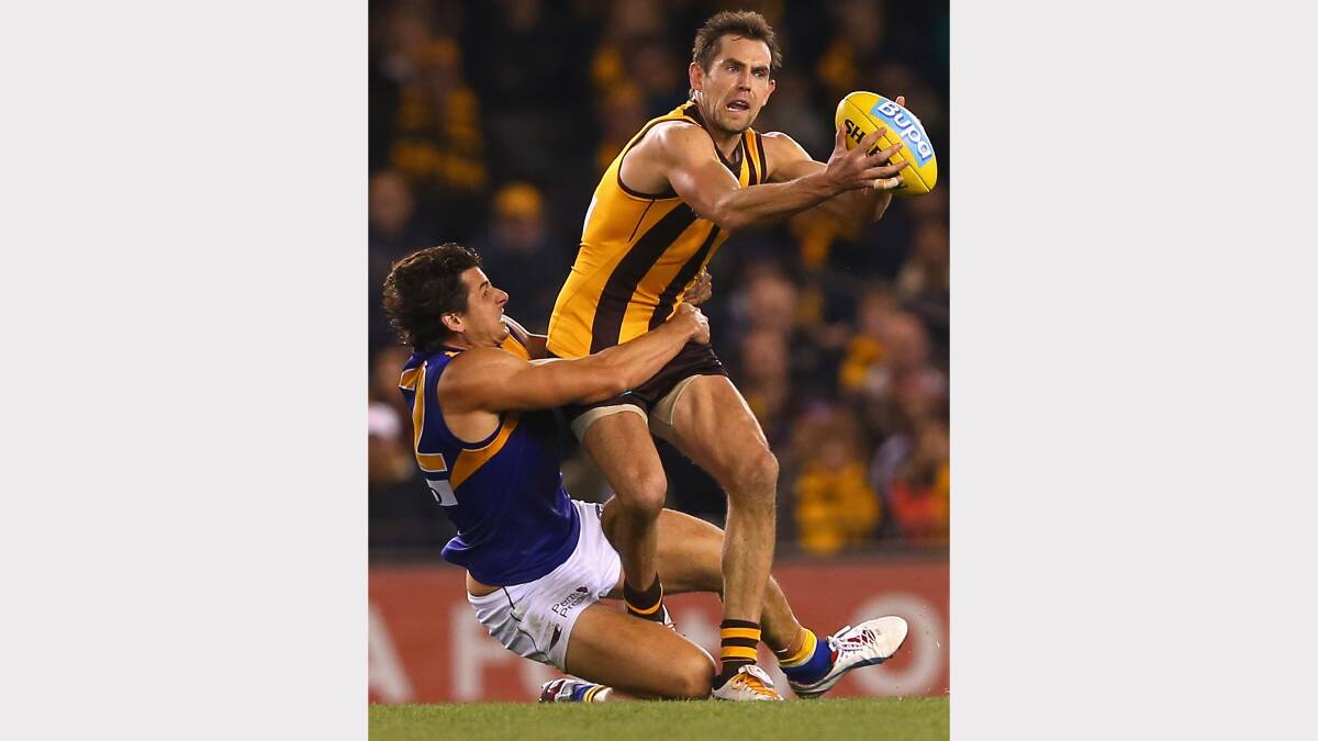 Hawthorn's Luke Hodge is tackled by Andrew Embley from West Coast. Photo: Getty Images.