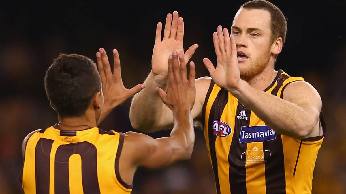 Hawthorn's Jarryd Roughead is congratulated by Bradley Hill after kicking a goal against the Eagles. Photo: Getty Images.