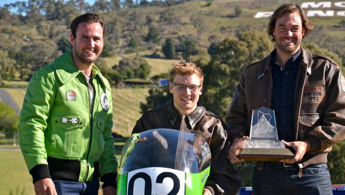 Rhys Hansford (left) wearing his Dads' former Kawasaki racing jacket, Jack Perkins with his Dad's 1993 Pole winning Jacket sitting on Gregg Hansfords 750cc winning motorbike and Ryan Hansford wearing his Dad's 1993 winning Pole jacket and holding Larry Perkins and Gregg Hansford's 1993 Bathurst 1000 winning trophy. Photo: Wade Aunger