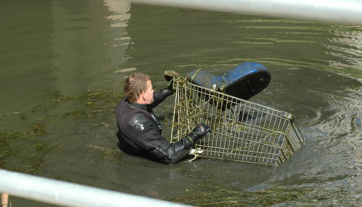 SEARCH: Another shopping trolly is pulled out of the creek.