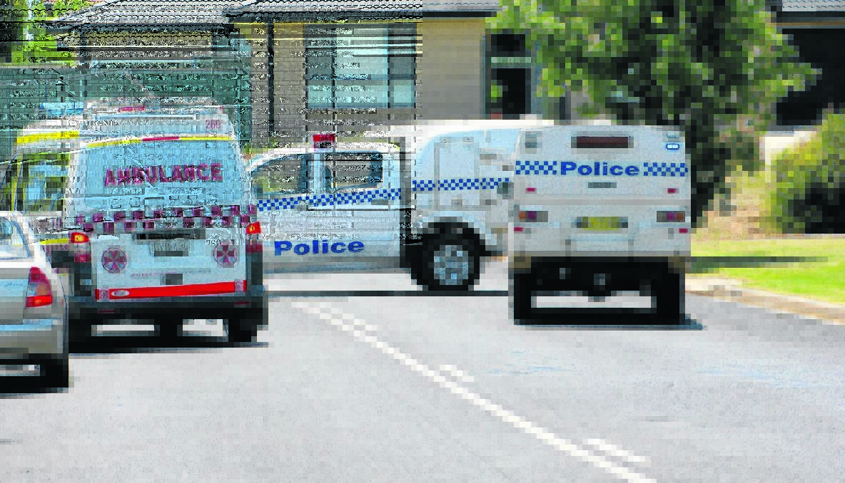 STABBING: Police and paramedics at the scene of the stabbing in 2012. 
