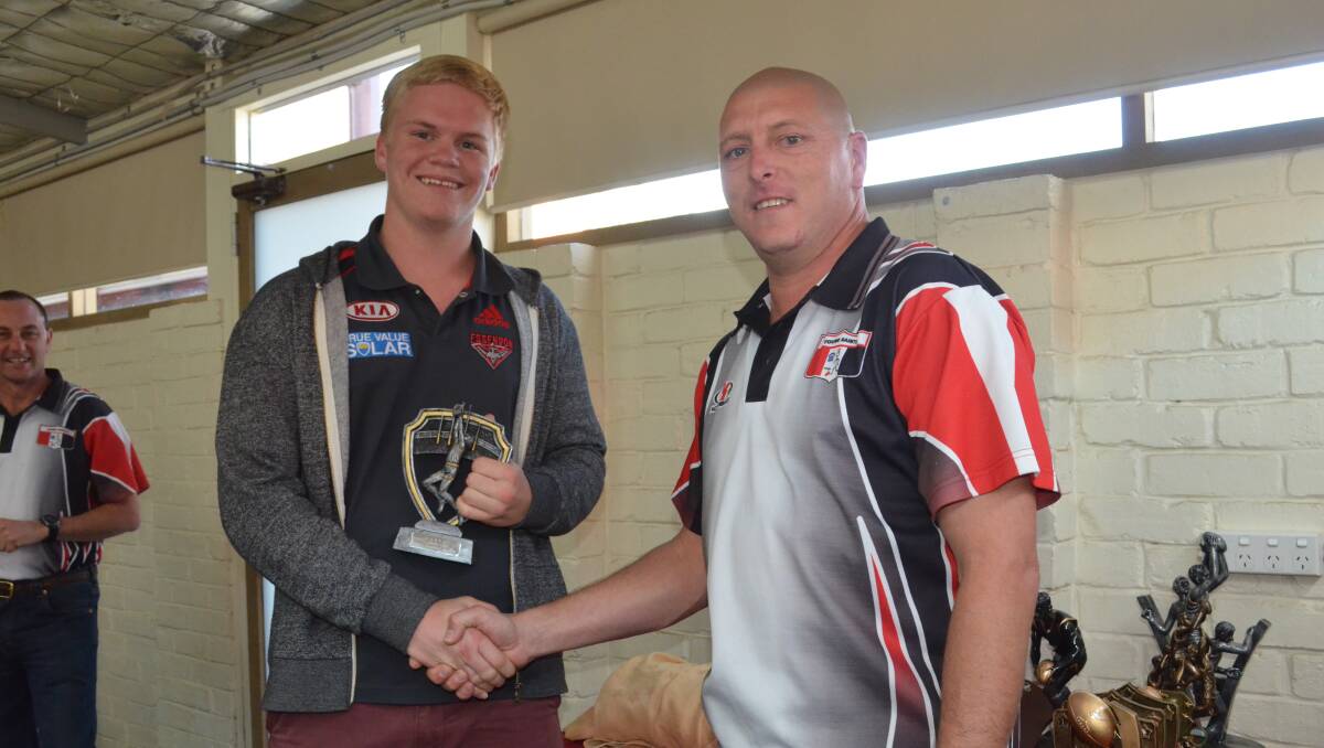 CLUBMAN OF THE YEAR (above): Under 18s coach Geoff Harmer (right) presents Harry McCabe with the Clubman of the Year award.  (aflpres018)