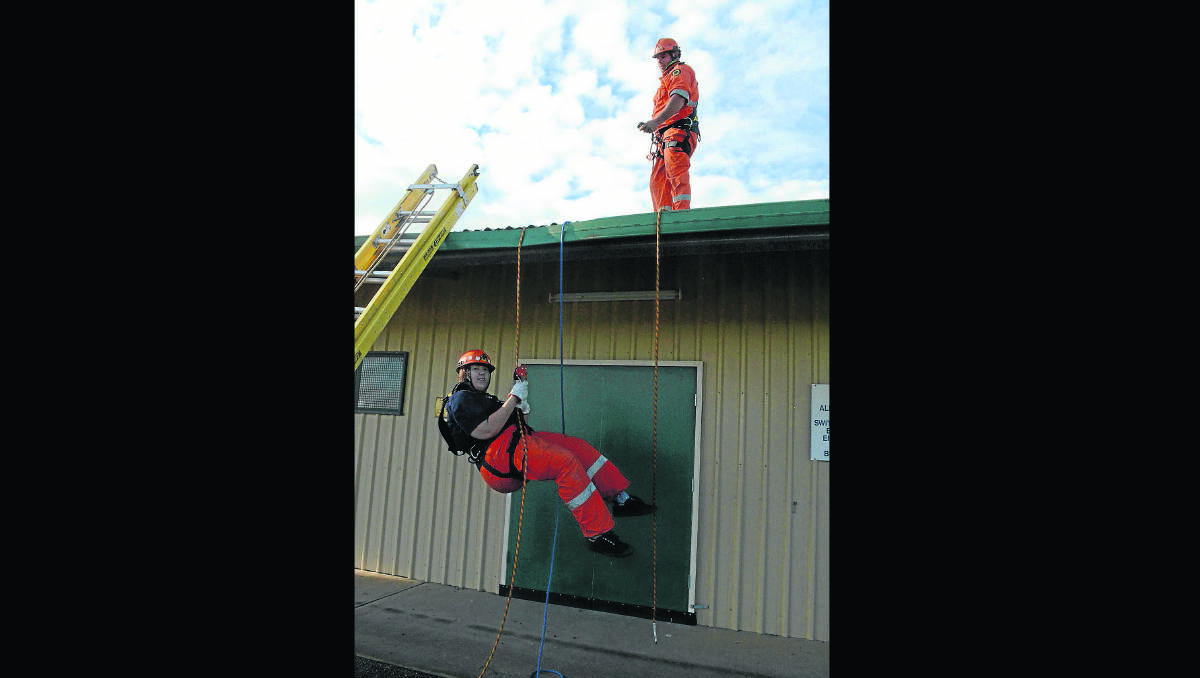 ROAD TEST: Young SES volunteers Bec Sheaff and Jamie Britt test the new roof harness equipment at the SES station in Rockdale Road.                                                 (sesequip1-18)