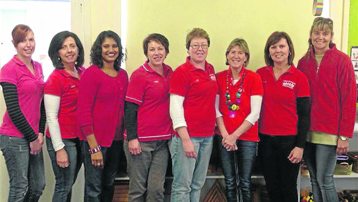 SEEING RED: Young Preschool staff (left to right) Jessica Hewitt, Regina Cant, Indra Nand, Debbie Jenner, Lyn Anderson, Angie Milne, Natalie Schiller and Teresa Waugh all wore red yesterday as part of a statewide protest.              (sub)