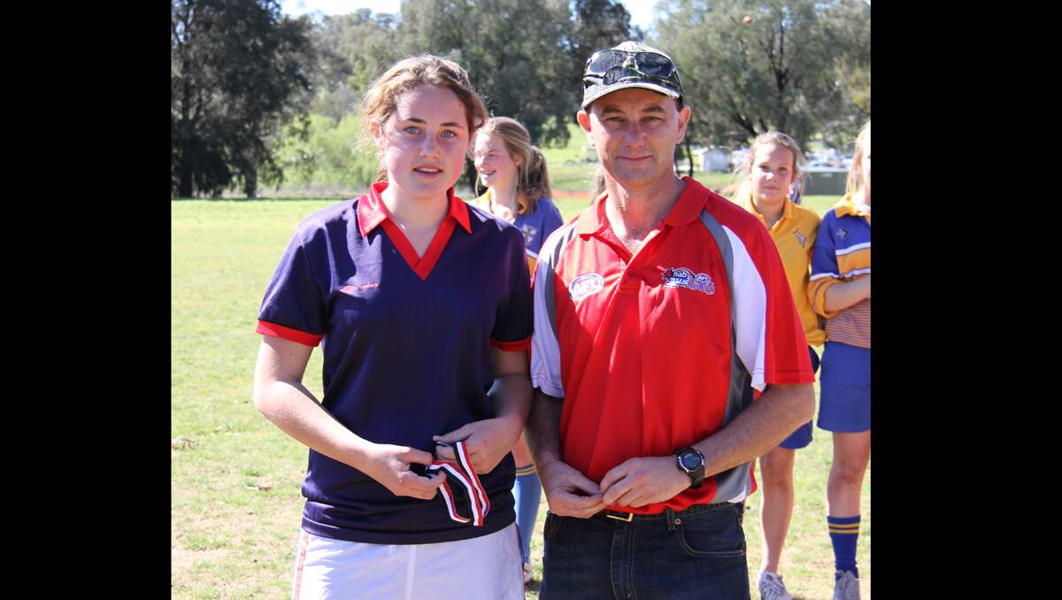 AWARD: Player of the Day went to Young High School’s Lucy Caldow, presented with her medal by Young Saints AFL Club president Mark Silk. 				    (sub)