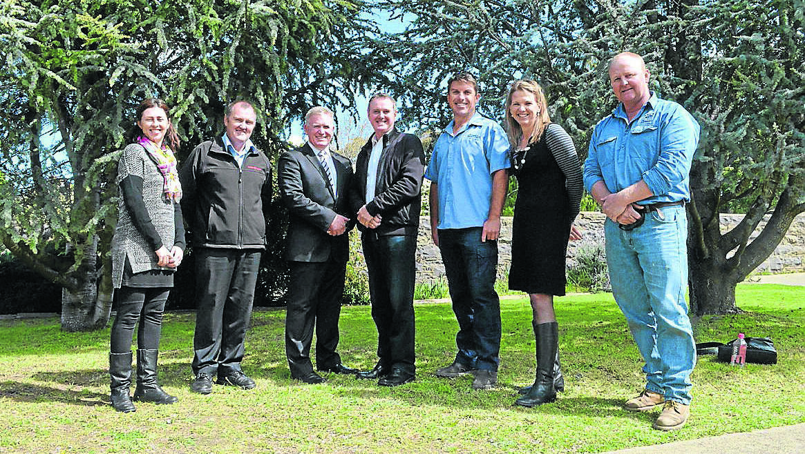 CONGRATULATIONS: Hennessy Catholic College principal Dr Peter Webster (third from left), with tender winner Adam Tanner of A.D. Tanner constructions (third from right), chairman of the Hennessy Community Council Bernard Maloney (second from left), St Mary’s parish priest Father Richard Thompson (centre) and Hennessy Community Council members (left to right) Natalie Turner, Lina Cavanagh and Gerard Trinder. 