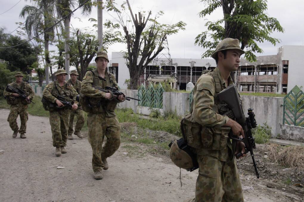 Peacekeeping soldiers from Australia patrol the street, June 30, 2007 in Dili, East Timor. Photo by Dimas Ardian/Getty Images