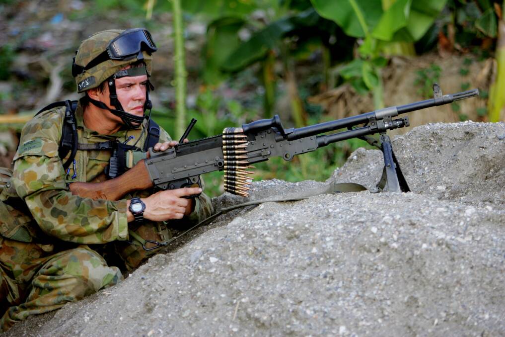 An Australian peacekeeper watches for violence June 3, 2006 in Dili, East Timor. Photo by Paula Bronstein/Getty Images