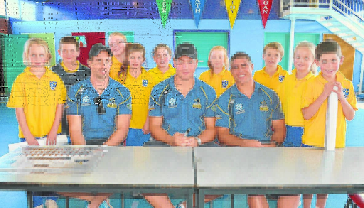 CELEBRITIES: The three visiting Brumbies, from left, Andrew Smith, Etienne Oosthuizen and Mark Swanpoel were treated a little like celebrities when they visited Young Public and St Mary’s Primary schools on Friday. Pictured from left, St Mary’s students Caitlin Thompson, Hunter Grosvenor-Peters, Beth Payne, Violet Cavanagh, Molly Coddington, Erin Pratt, Harry Nuthall, Lily Coddington and Charlie Sullivan. 