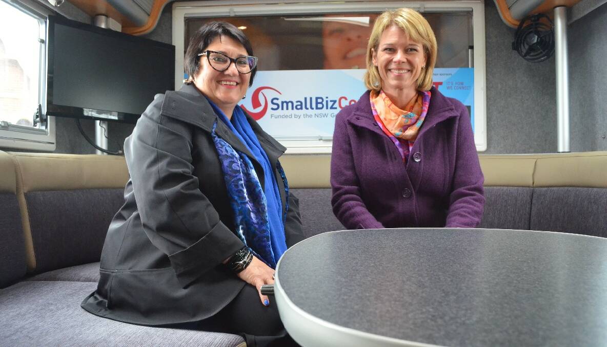 Minister for Small Business Katrina Hodgkinson and NSW Small Business Commissioner Yasmin King give members of the pubic a little tour inside the bus.