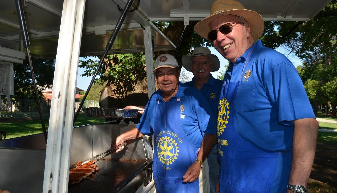 SNAGS: Rotary Club members Murray Napier, Terry Norwood, Cliff Sheridan cook up a tasty breakfast barbeque.