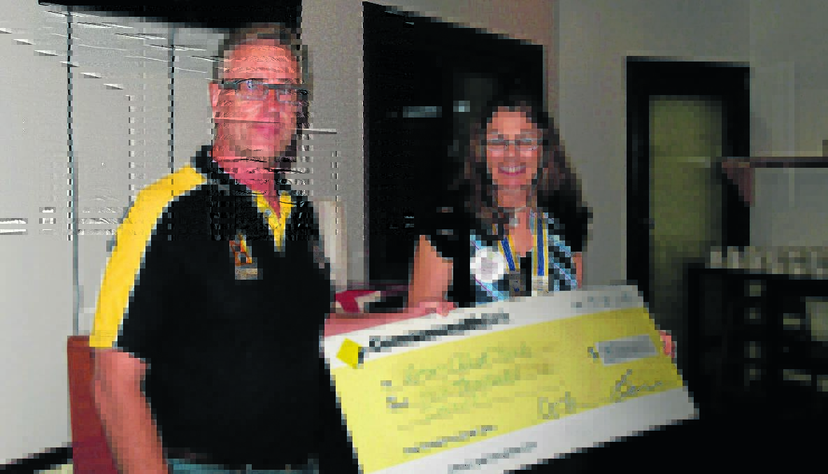 CHEQUE: Chris Edwards from the Rotary Club of Hall (Canberra) travelled to the meeting of the Young Rotary Club to present a cheque of $5000 to Young Rotary Club president, Jenny Somerset. 	
