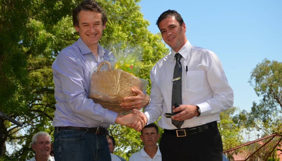 GIFT: Woolworths assistant store manager Shaun Balzan (right) thanked Young's Australia Day ambassador Jon Dee for coming to the town for the celebrations.