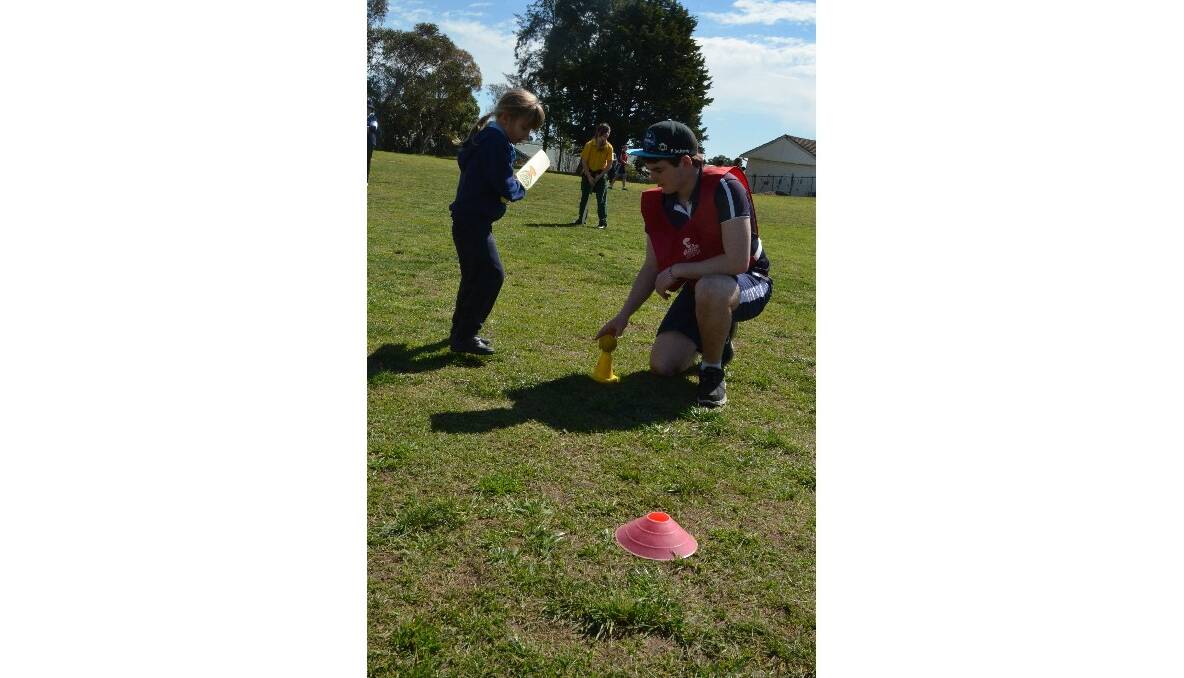 Young High student Josh Reynolds helps Hayley Bourke from Young North Public School. Photo: Christine Speelman