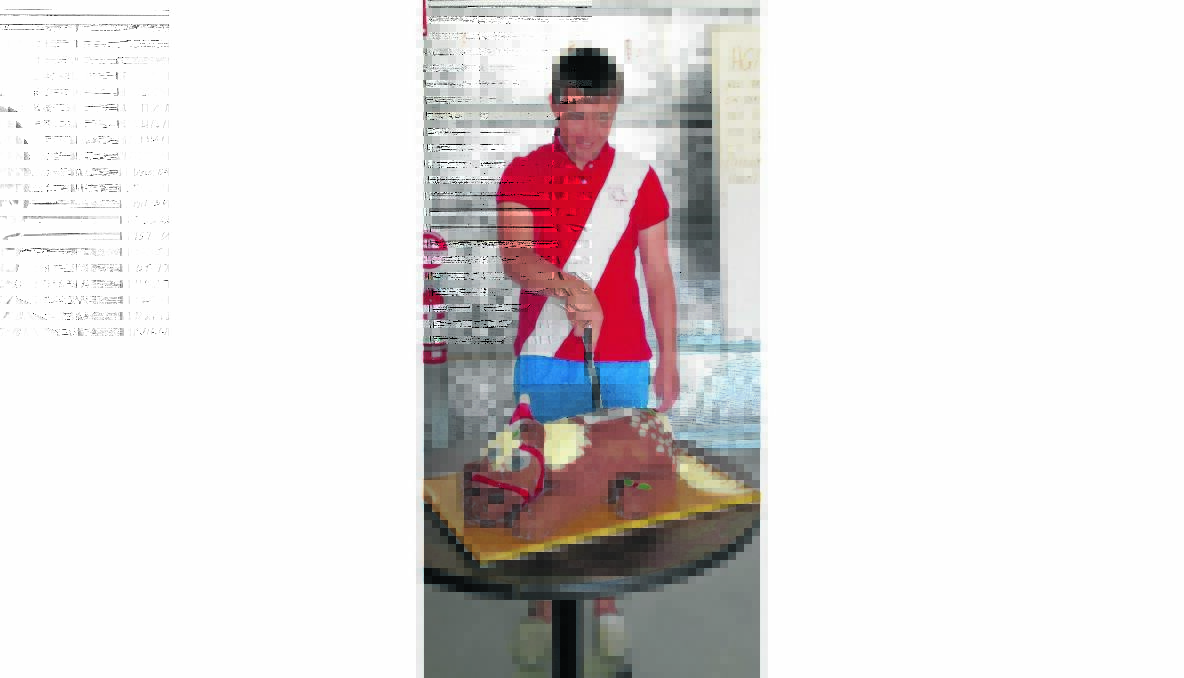 PARTY: Jonathon Scott,  winner of the YPC President’s Award, cutting the Christmas cake. 
