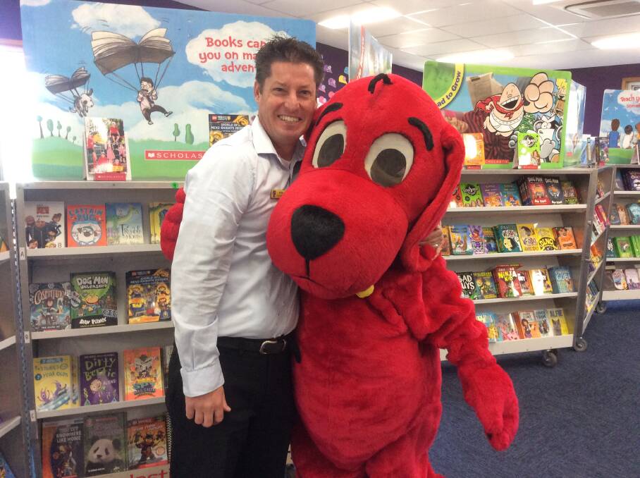 St Mary's teacher Mark Birks with Clifford the Big Red Dog at the school's Book Fair.