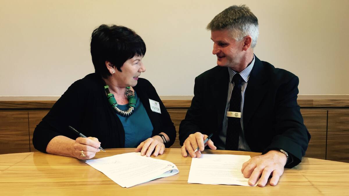 FOR THE COMMUNITY: Susan Brindle and Brian Ingram signing the Memorandum of Understanding. 