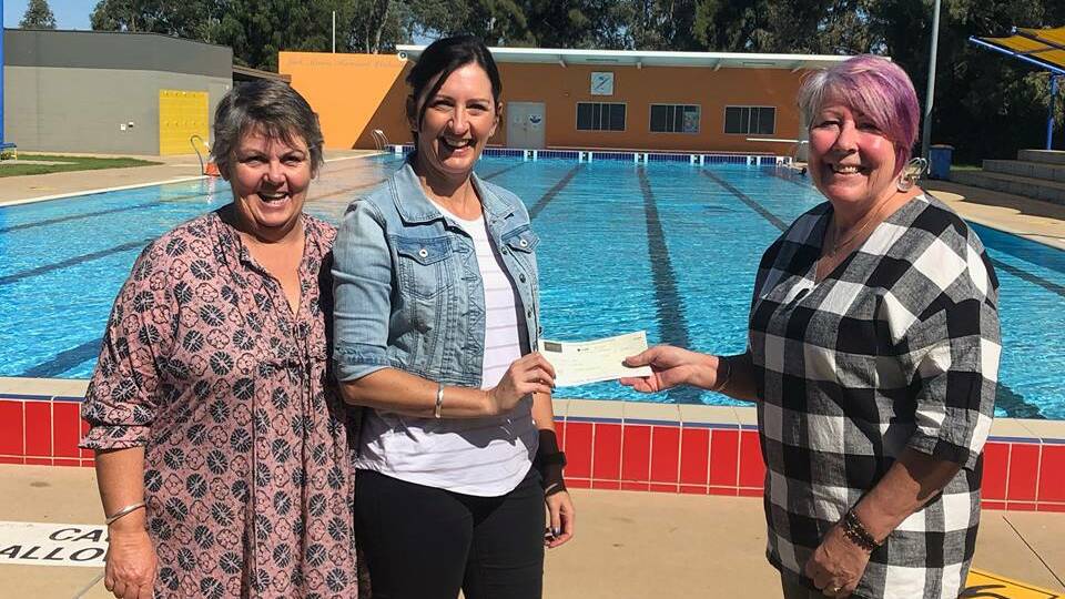 Trisha Hill and Teena Whitechurch from Young Community Chest receiving the cheque from Young Aquatic Center Aqua Aerobics Instructor Lenore Schiller. Photo: Rebecca Hewson.