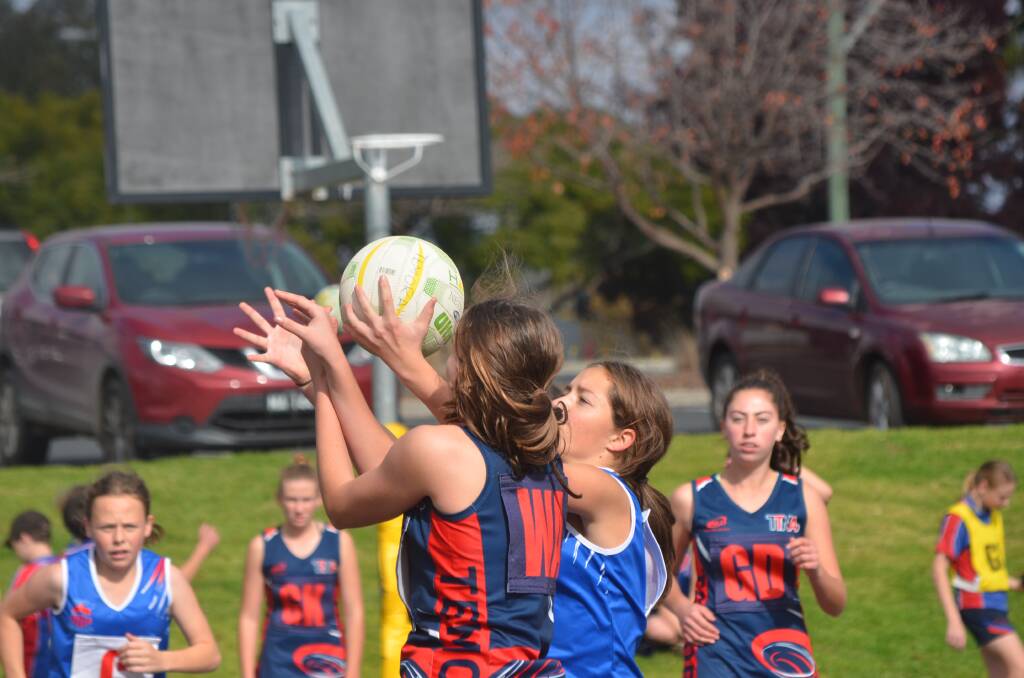 A Temora player fights for the ball on the field.