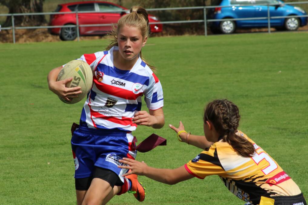 Belle Whitechurch evades the opposition during the girl's league tag game.