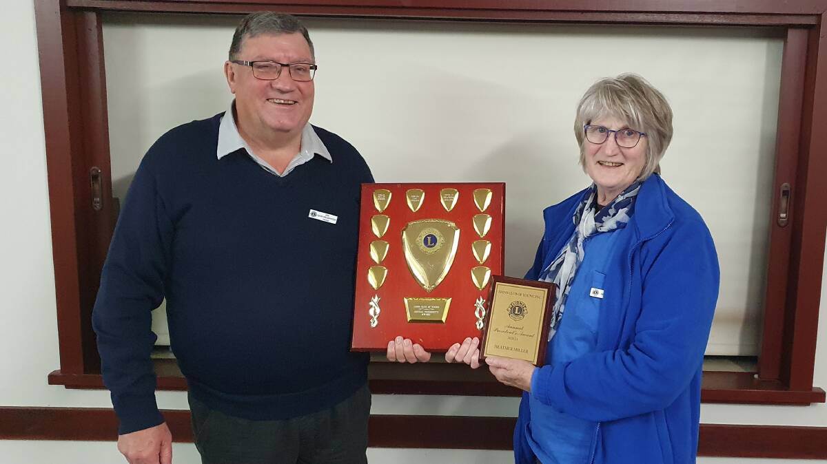 Past President Geoff presenting the President's Award to Heather.