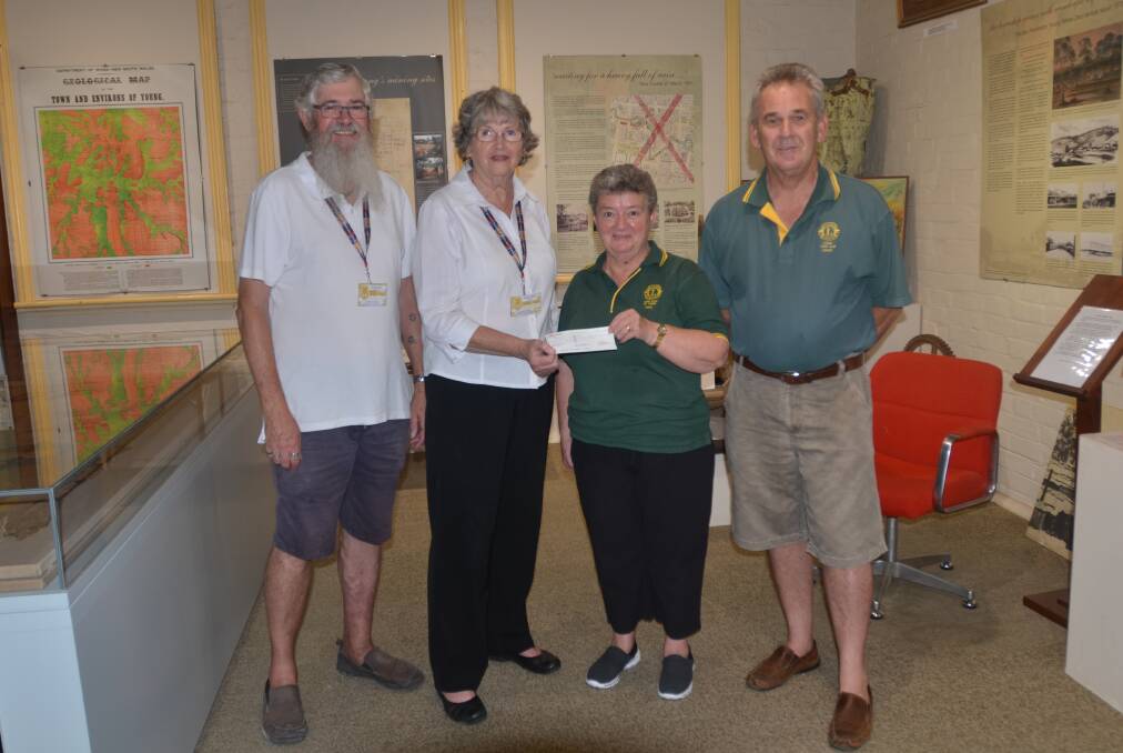 Young Historical Society president Kevin Stemm and Marilyn Stemm accept the Young Lions Club generous donation last week.