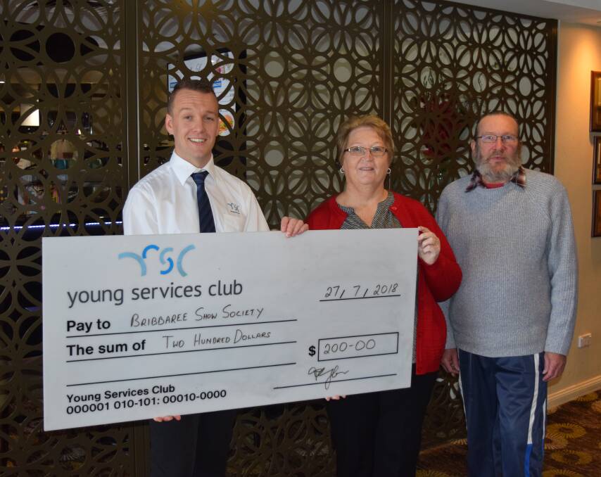 Bribbaree Show Society Secretary, Reece Hanigan and Treasurer, Pat Potbury receive Young Services Club sponsorship from Sam Parkes for the Annual Show.
