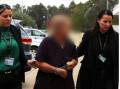 Anne Geeves is lead away by detectives during her arrest. Photo NSW Police.