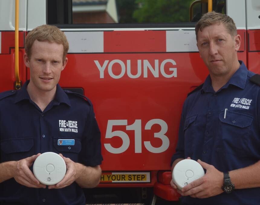 FIRE SAFE: Firefighters Don Thomas and Rob Daniels with 10-year lithium battery-powered photoelectric smoke alarms. Picture: Craig Thomson.