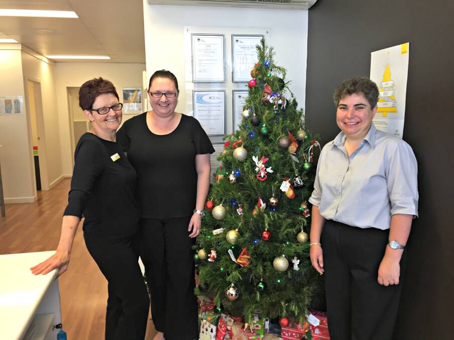 Giving the gift of Christmas: Ray White's Robyn Brown, Anna Long and Janelle Sutton have partnered with Young Crisis Accommodation Centre to help disadvantaged children this Christmas. Photo: Craig Thomson.