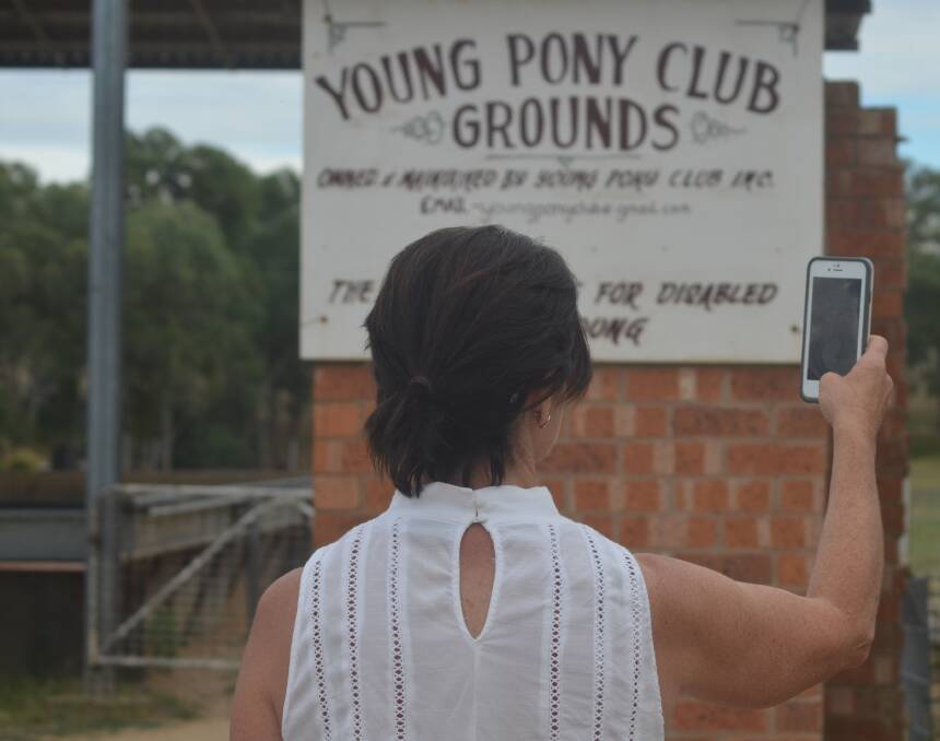 MOBILE BLACKSPOT: A local resident tries to get a mobile phone signal at the Young showgrounds. Picture Craig Thomson.