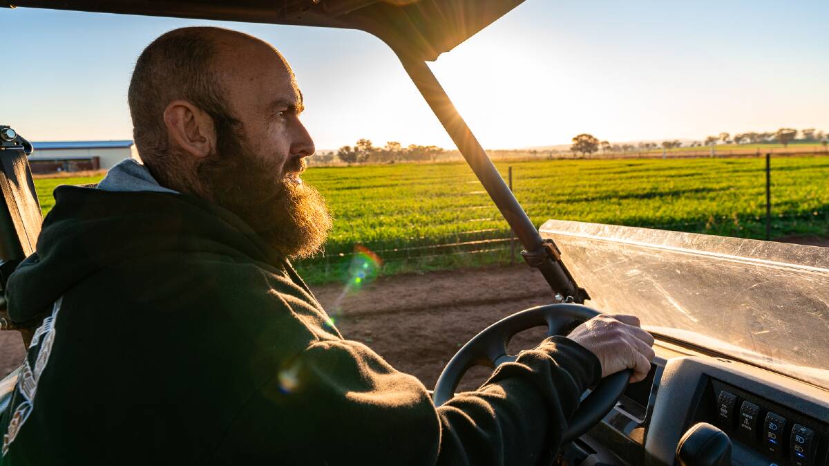 Pete Gerber at Pioneer Brewing near Orange, NSW, drives past the barley he grows on the brewery's farm.