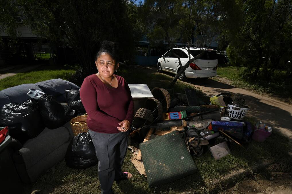 'BUGGERED': Marlene Weribone stands with a pile of waterlogged furniture she had to get rid of after the flood in Moree. Photo: Gareth Gardner