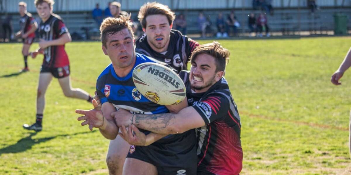 Bears player James Spirovski makes a tackle during the Western Community Cup last year, with Aiden Miller in the background. Photo: Simon Apps 
