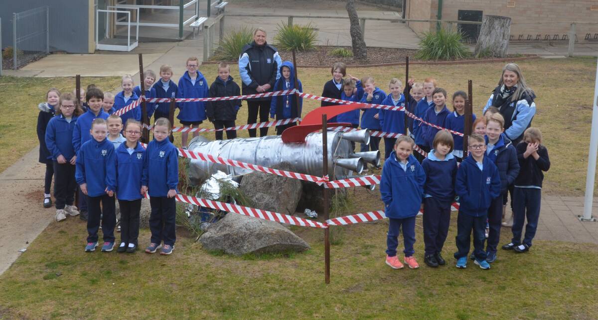 Year one teachers Brooke McIllhatton and Lucy McMillan with students from Year one pictured inspecting the rocket crash site.