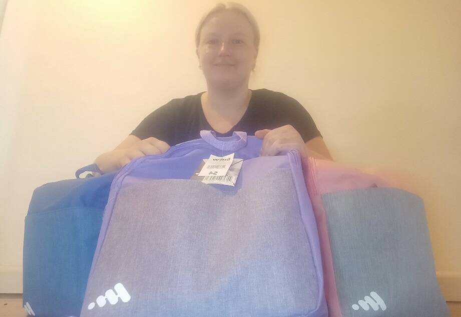 Alexandra Podgorski with some of the new backpacks ready to help students in fire affected communties. Photo: contributed
