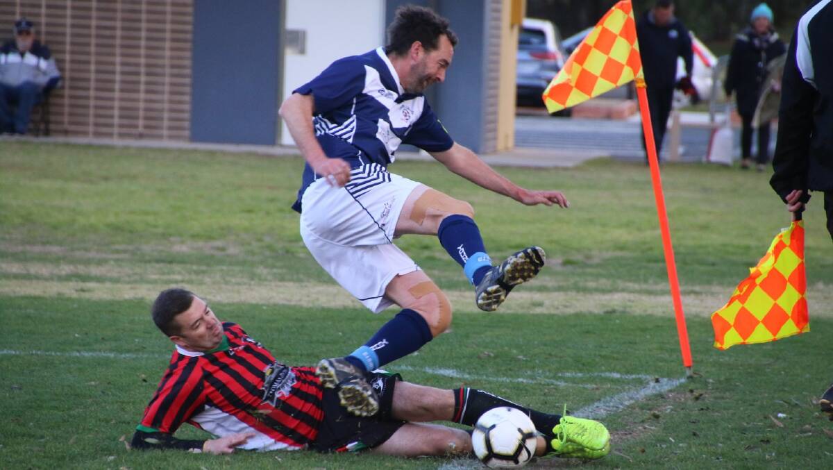 Andrew Carberry is tackled by a Lake Albert defender during Young's 2-0 loss in the major semi-final on Saturday afternoon at Wagga's Harris Park.