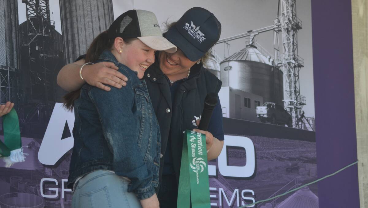Young Show Society president Sam Reynolds thanks Bridie Gibson for her assistance in organising the 2019 Young Ag Show, presenting her with an ASC Next Generation ribbon.
