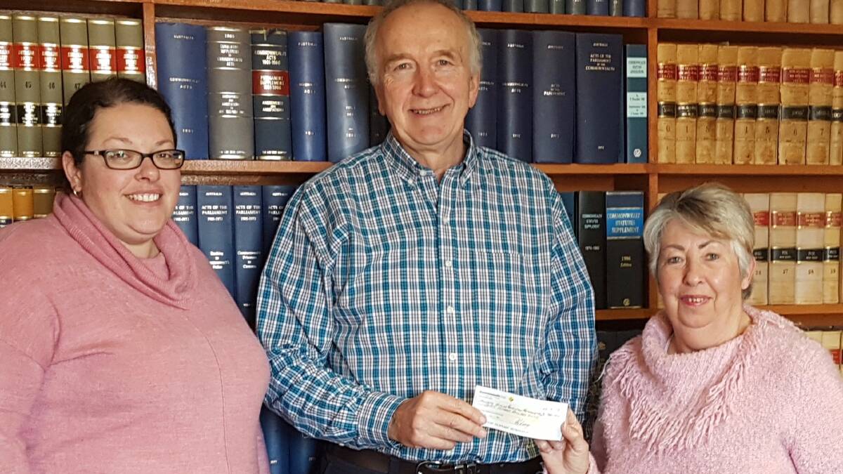 Eris Gleeson of the Hilltops Suicide Prevention Network accepting a cheque for $700 from Tracy Clark (left) and Carole Clark (right) on behalf of Macquarie Singers.