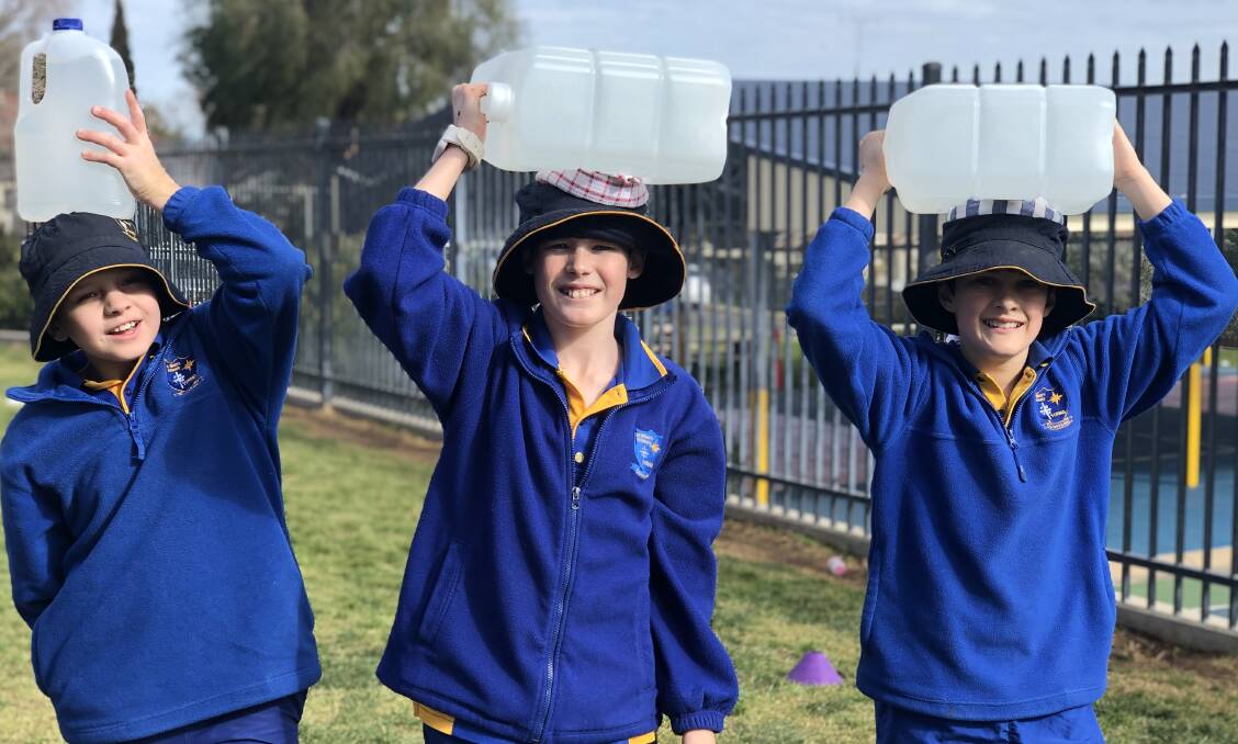 Year 6 students Declan Gibbons, Ashley Perkins and Dominic Cusack raising money for Water for South Sudan. Photo: contributed 
