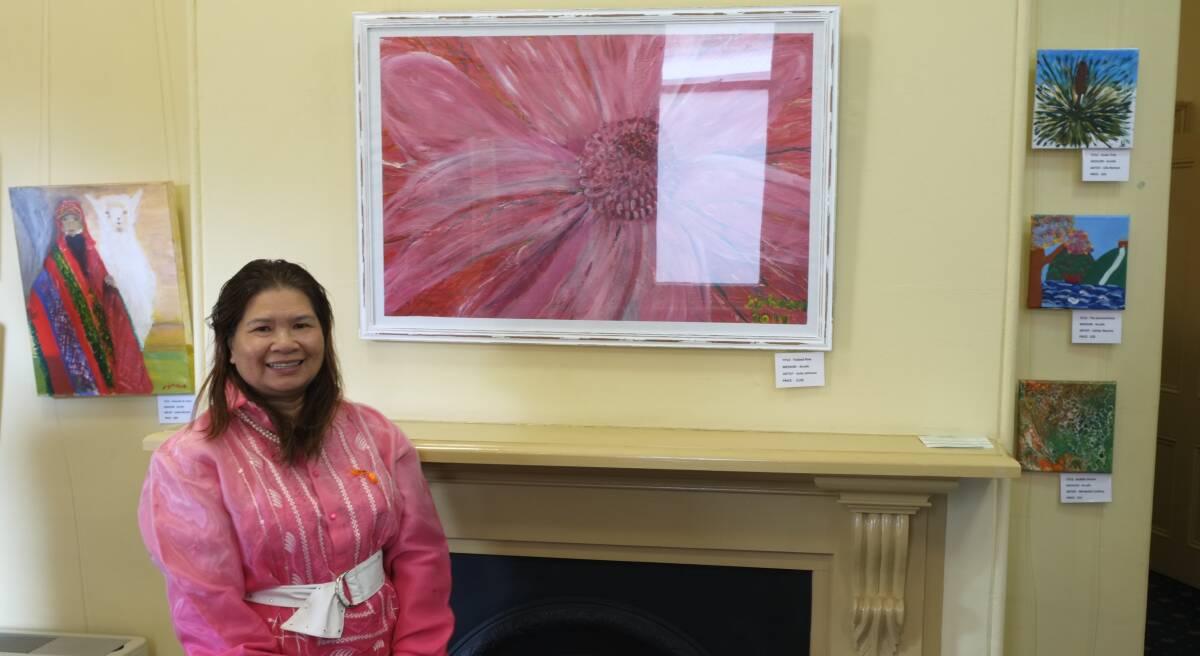 Josie Johnson pictured with her painting on display at the Burrangong Gallery. Photo: Caitlin Sheedy