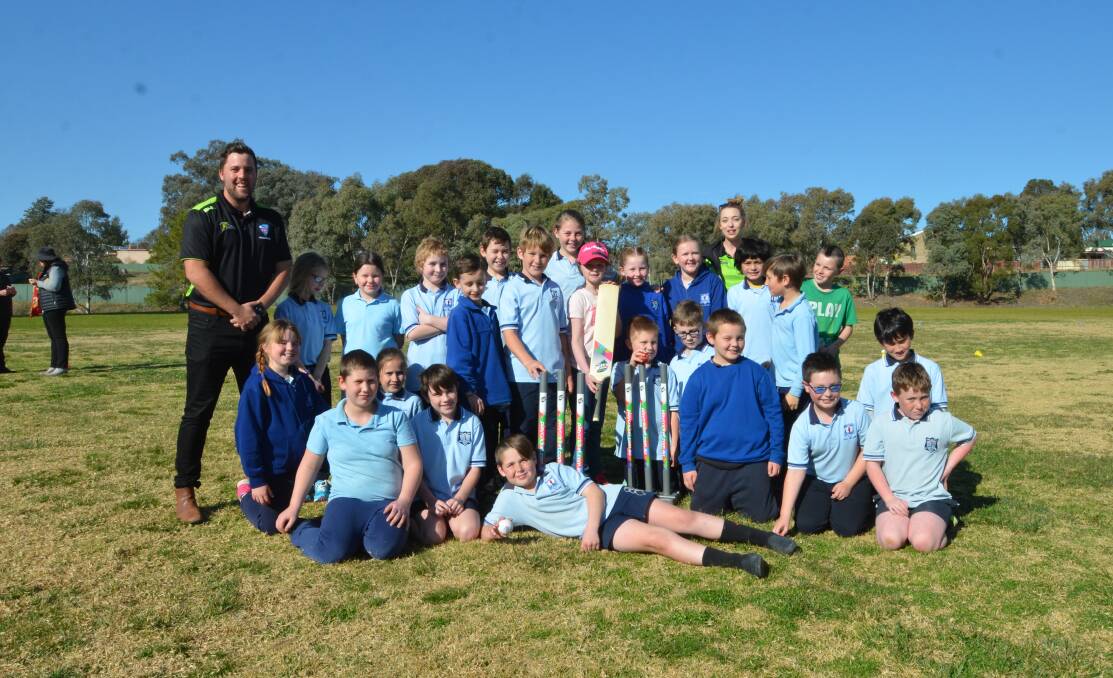 Cricket NSW representatives Michael Minns and Emma Webb-Wagg with students from Young North Public School on Wednesday afternoon.