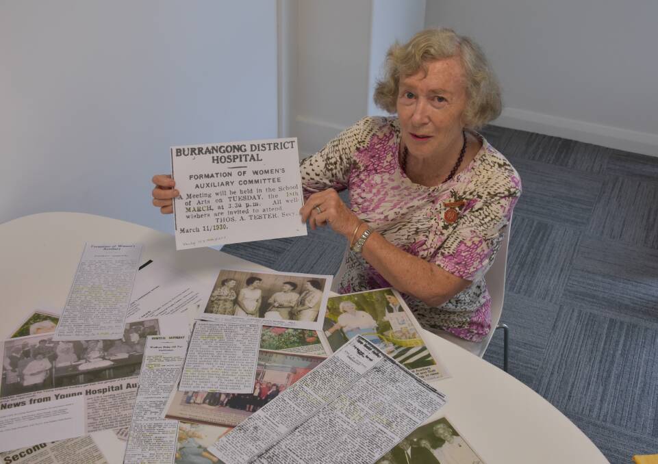 Hospital Auxiliary president Janice Ward with paper clippings from the past 90 years. Photo by Peter Guthrie