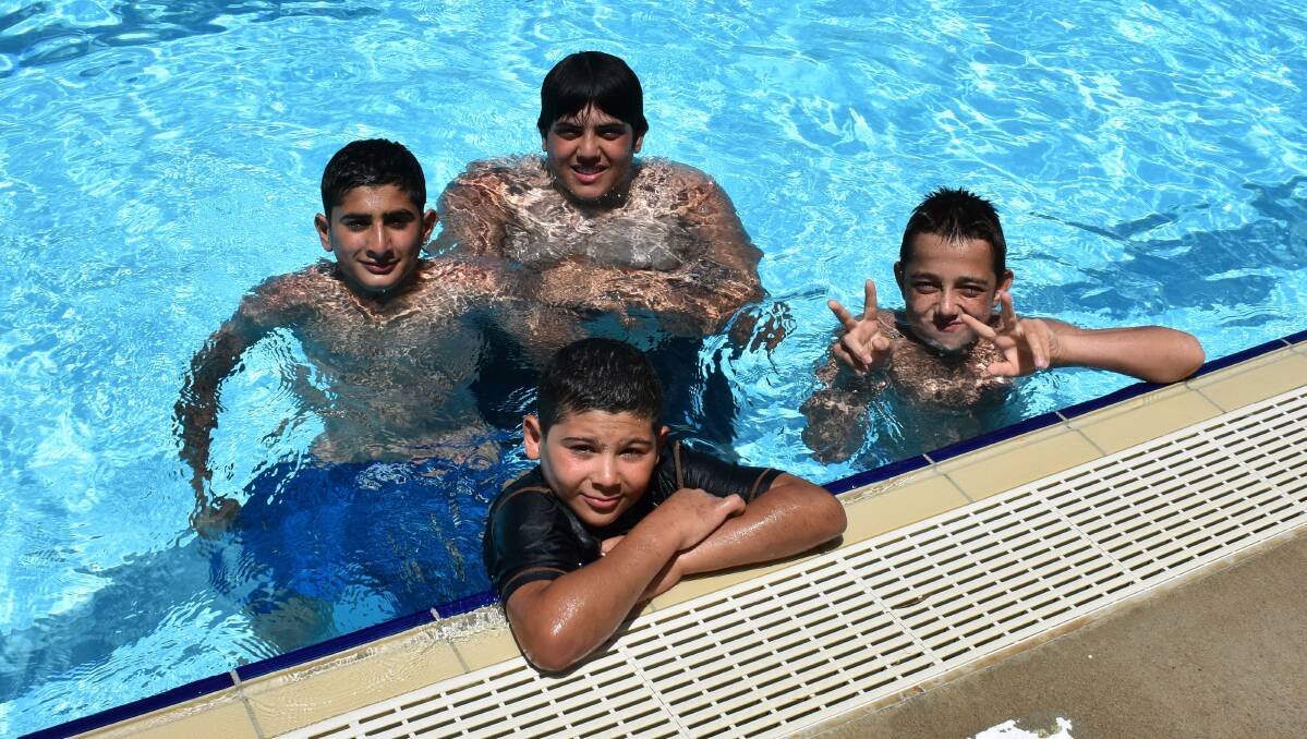 Noah Khodr, Aymen Chemeit (front), Adam Khodr and Abdullah El Sabsabi (back) cool off at Young Aquatic Centre on Wednesday. Photo: Peter Guthrie