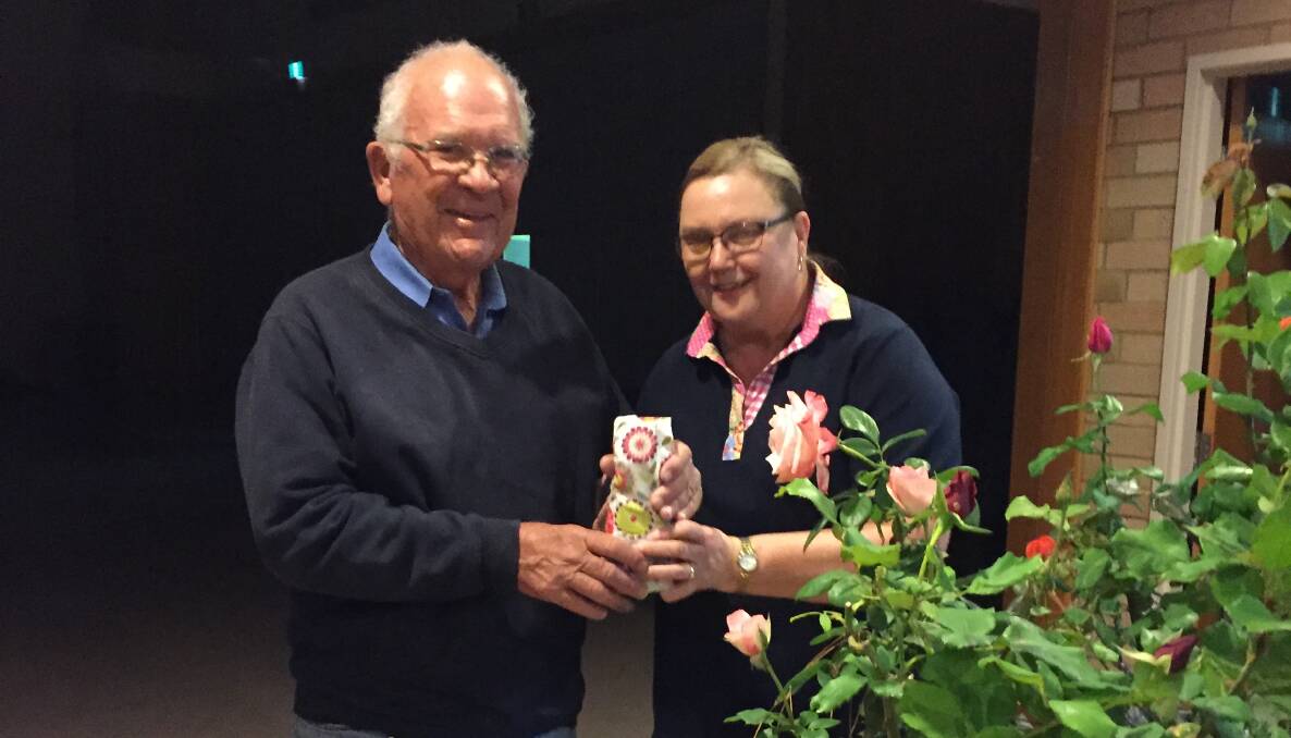 Young Garden Club treasurer presenting the guest speaker Ken Langton with a thank you gift.