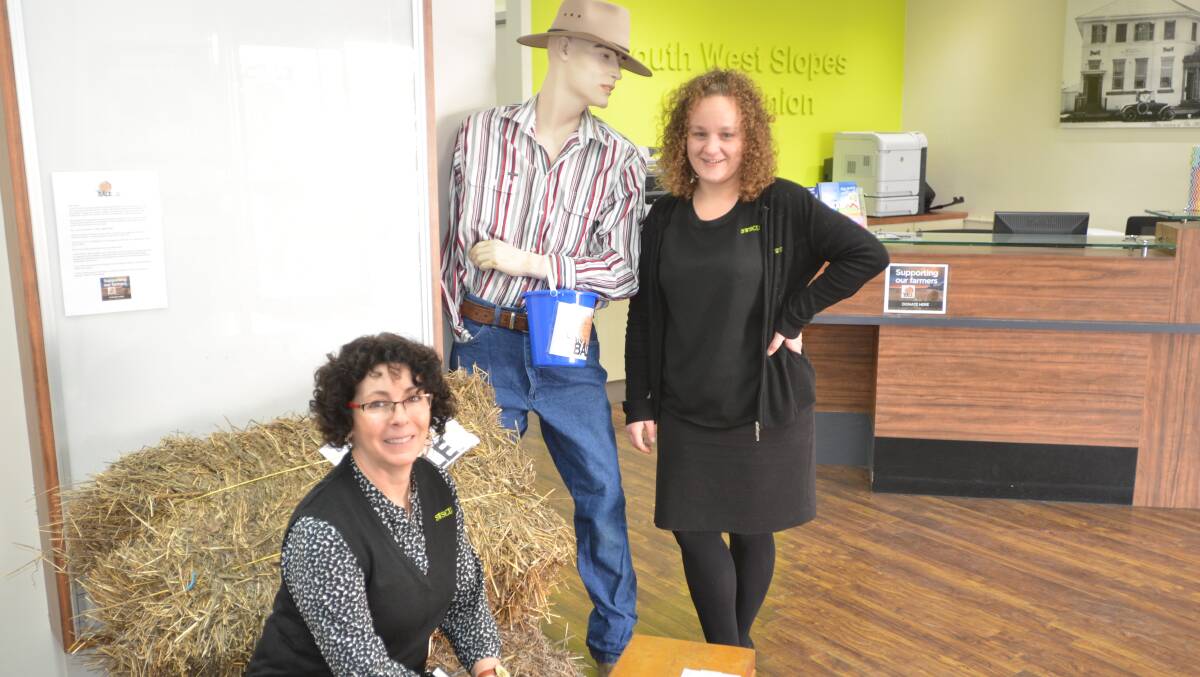 Vicki Maxwell and Erin Anderson pictured at the South West Slopes Credit Union. A sausage sizzle on Friday is raising money for battling farmers.