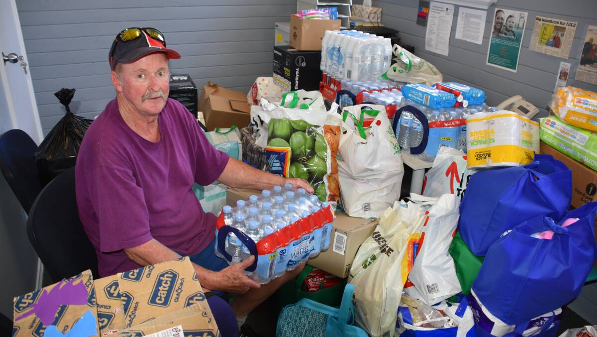 Paul Bailey in a room at the Hilltops Community Hub packed with donations to help communtiies and firefighters battling bushfires in northern NSW. Photo: Peter Guthrie