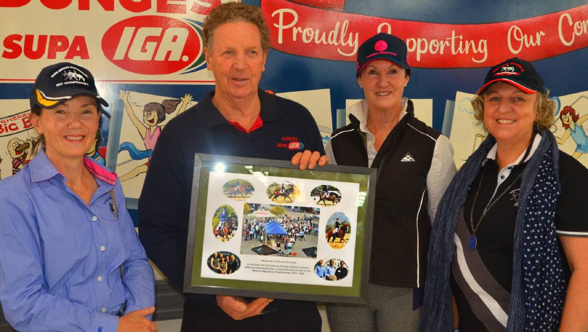 Julie Vandyke, Sue Walker and Kim Lang present Robert Donges with a token of the Young Dressage Association's thanks for 10 years of support. 